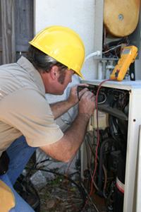 An air conditioning specialist repairing an AC unit